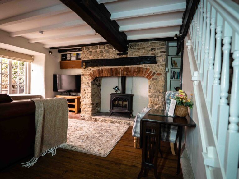 The sitting room fireplace with exposed brick