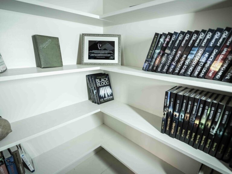 A bookshelf in the cottage filled with Wild Fens novels